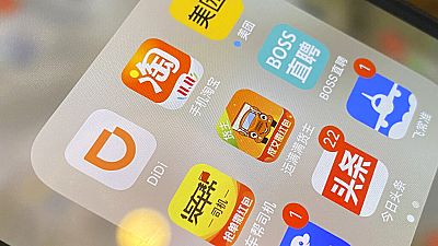The ride-hailing app Didi is seen near other Chinese apps on a phone in Beijing The ride-hailing app Didi is seen near other Chinese apps on a phone in Beijing