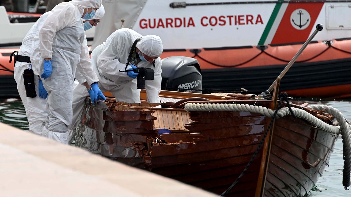 Italian forensic police inspect the damage on the couple's boat.