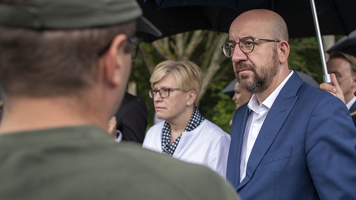 European Council President Charles Michel and Lithuania's Prime Minister Ingrida Simonyte speak with members of the Lithuania State Border Guard on Tuesday.