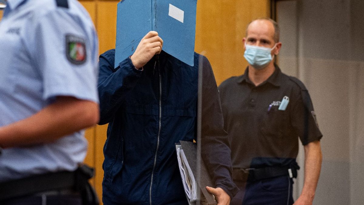The main defendant hid his face as he arrives for sentencing at the court in Münster.