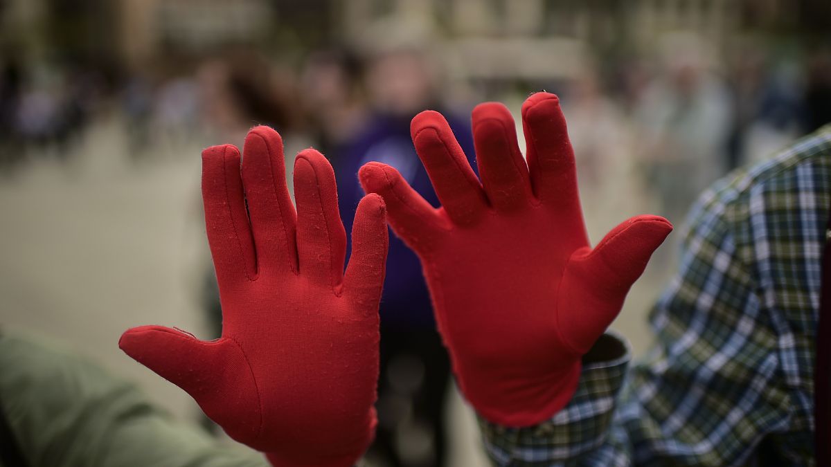Protestors wearing red gloves take part in a protest against male sexual violence in Pamplona in 2018.