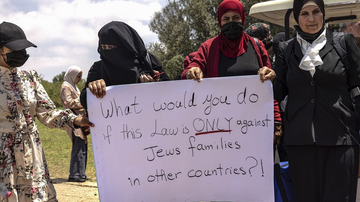 Women protest ahead of a vote by Israel's parliament on renewing a law that bars Arab citizens of Israel from extending citizenship or even residency to spouses. 