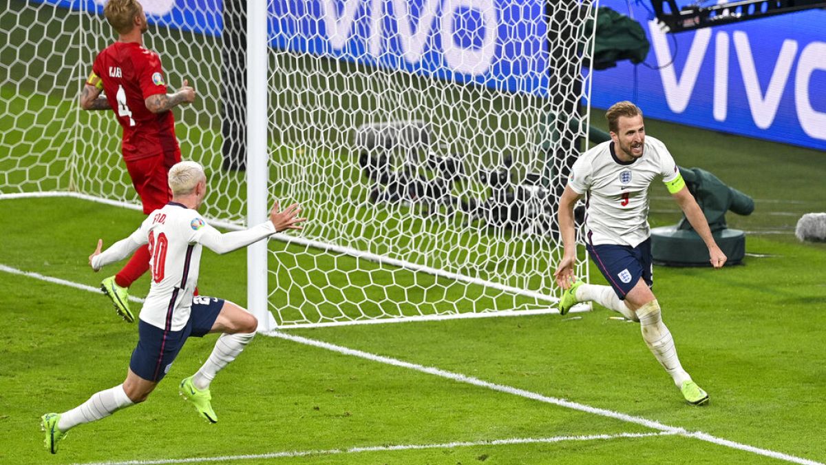 England's Harry Kane, right, reacts after scoring his team's second goal during the Euro 2020 soccer championship semifinal between England and Denmark at Wembley stadium.