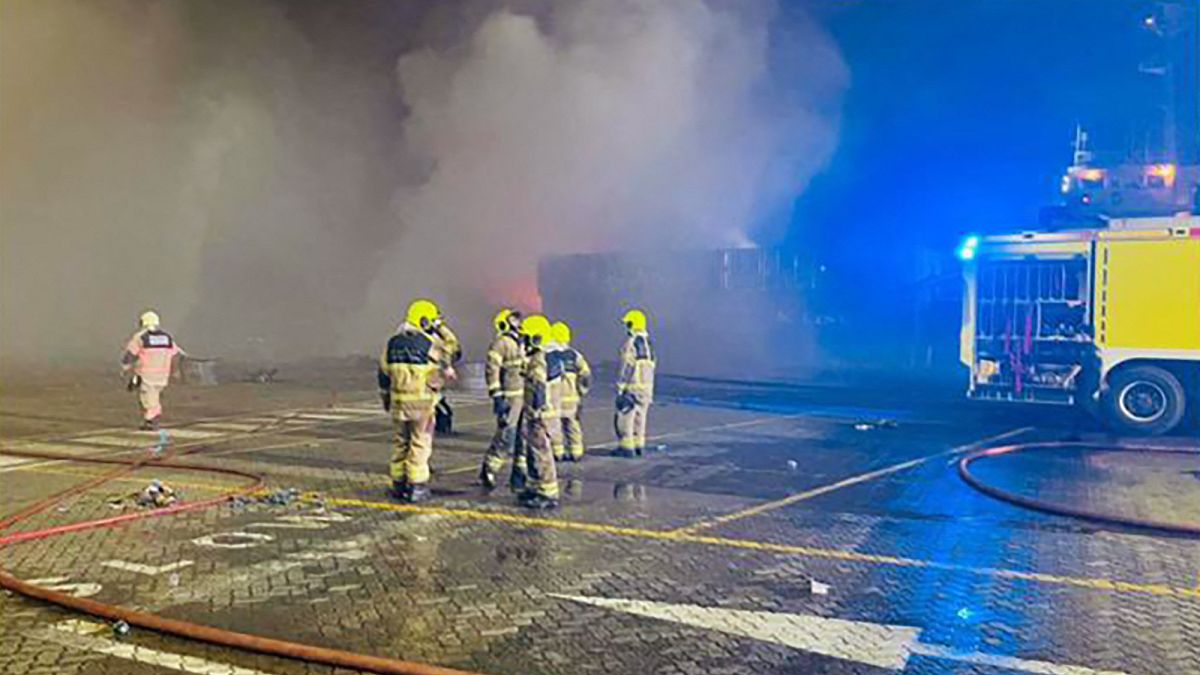 رجال إطفاء تابعون للدفاع المدني في موقع الحريق الذي اندلع في ميناء جبل علي الرئيسي في دبي إثر انفجار.