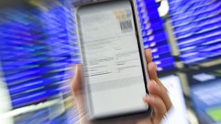 A woman shows her EU Digital Covid certificate on her mobilephone