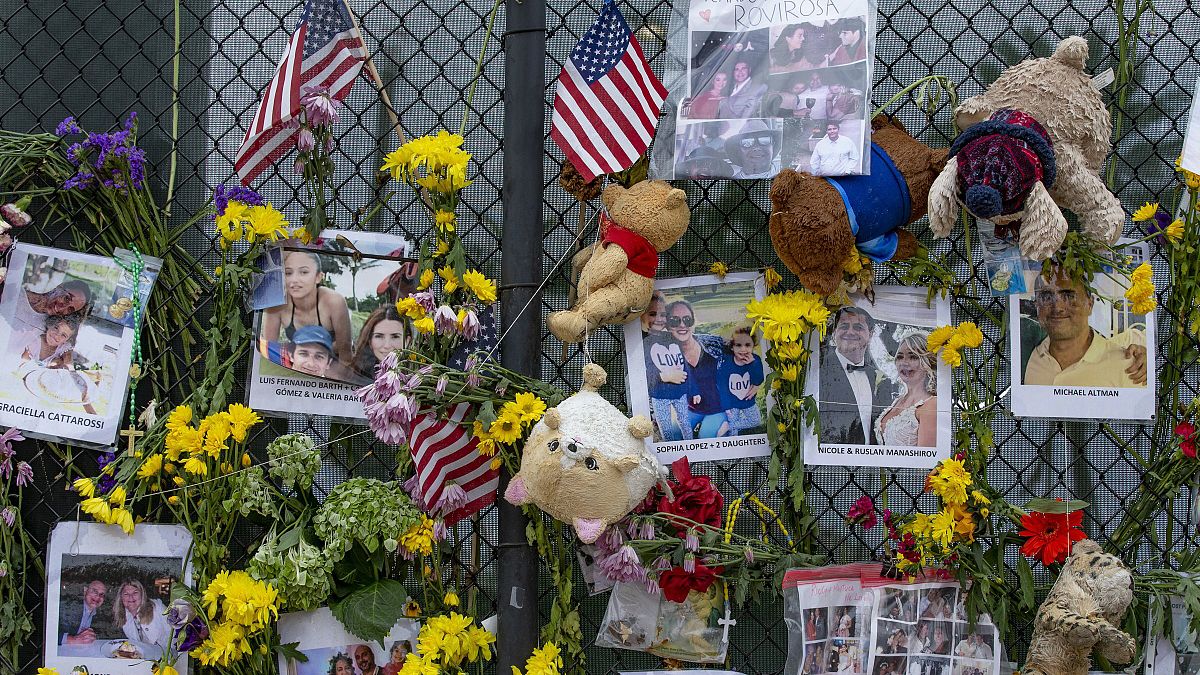 Momentos and flowers are seen displayed at the Surfside Wall of Hope & Memorial on Wednesday, July 7, 2021.