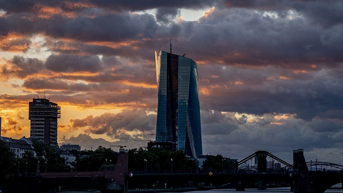 The sun rises behind the European Central Bank in Frankfurt, Germany. 