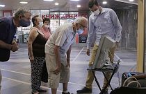 Elderly people look at a voting machine presented by Central Election Commission in Sofia