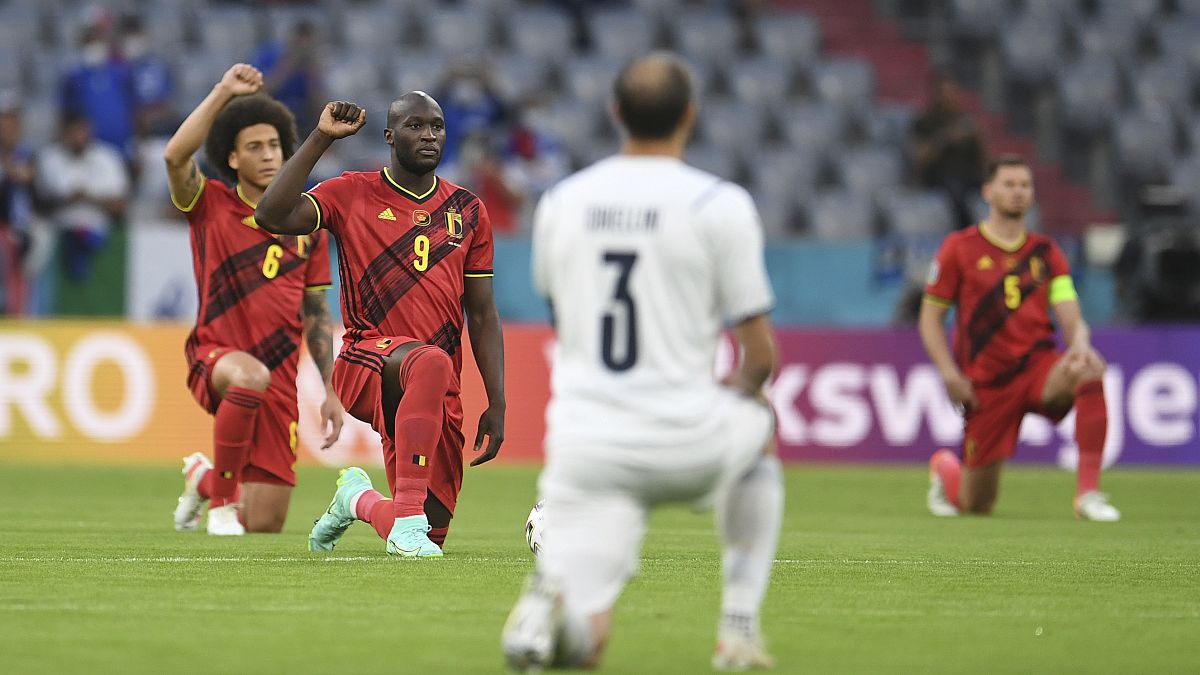 Players take a knee before a Euro 2020 match between Belgium and Italy.