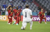 Players take a knee before a Euro 2020 match between Belgium and Italy.