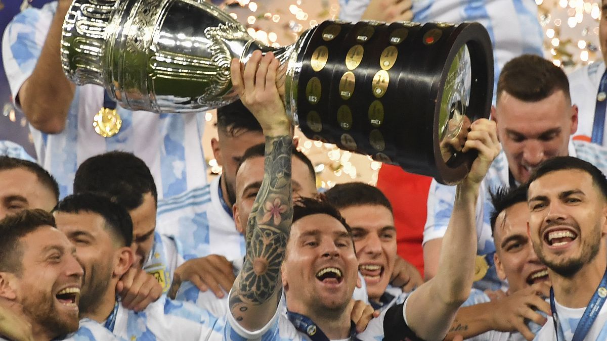 Argentina's Lionel Messi holds the trophy 