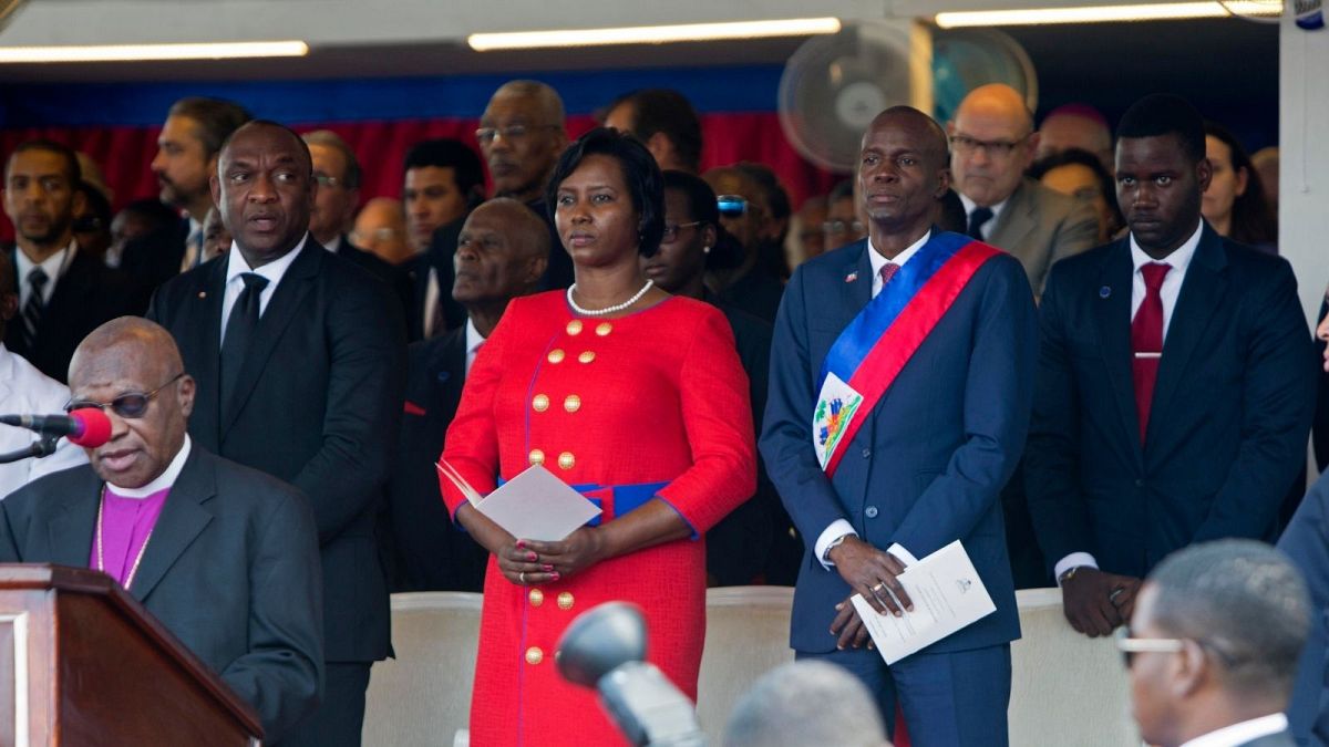 Haiti's President Jovenel Moise stands with his wife Martine during a Mass