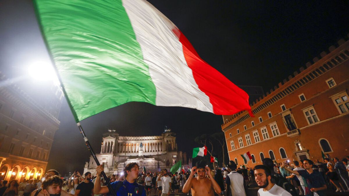 Italy's fans celebrate in Rome, Monday, July 12, 2021, after Italy beat England to win the Euro 2020 soccer championships in a final played at Wembley stadium in London. 