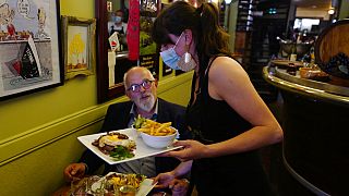 Pierre, 69, enjoys a meal in a restaurant during the nationwide reopening of restaurants, in Lille, northern France, Wednesday, June 9