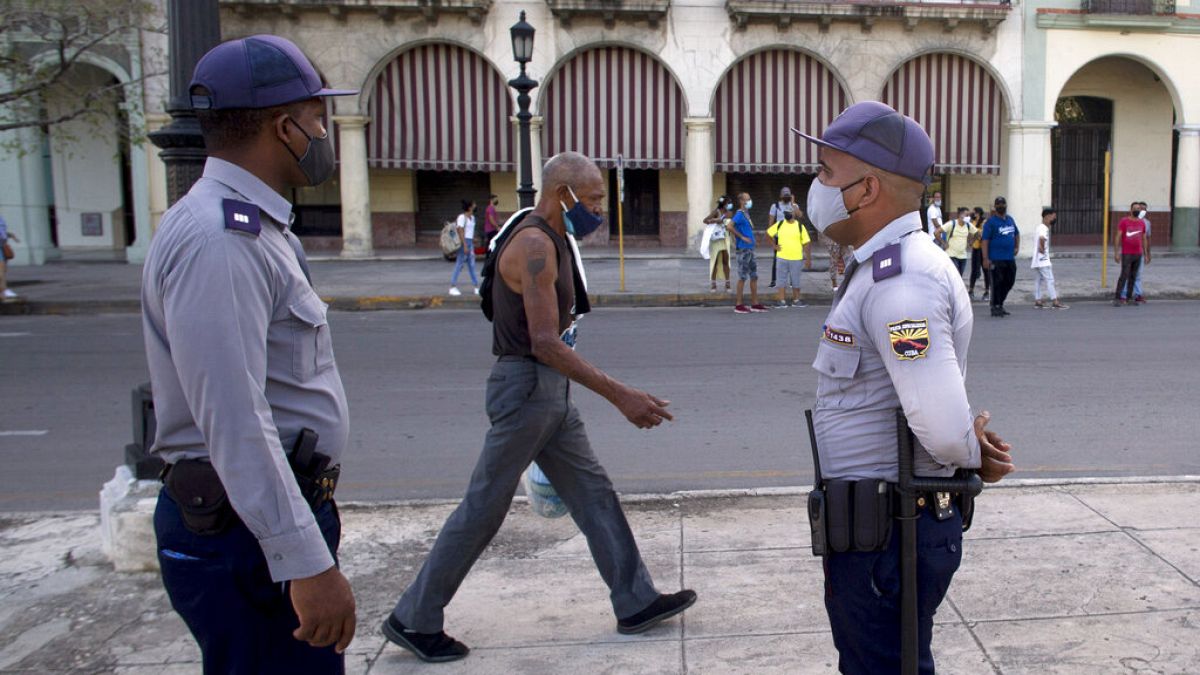 Police stand guard near the National Capitol building in Havana, Cuba, Monday, July 12, 2021