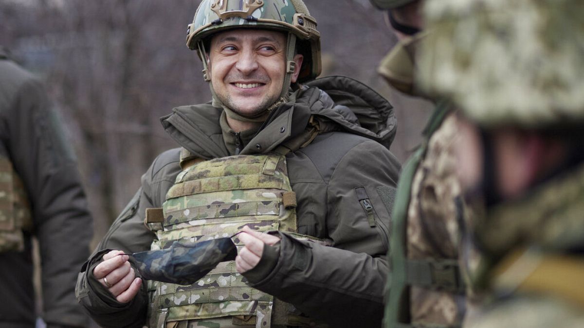 Ukrainian President Volodymyr Zelenskyy talks with servicemen as he visits the war-hit Donetsk region, eastern Ukraine. 