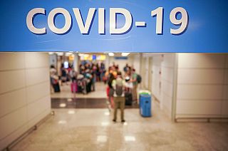 n this Aug.16, 2020 file photo, vacationers arriving in Rome from four Mediterranean countries, Croatia, Greece, Malta and Spain, line up with their suitcases at Rome airport.