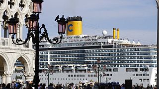 A cruise ship passes by St. Mark's Square filled with tourists, in Venice, Italy, Sunday, June 2, 2019.