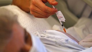 Dr. Cedric Waechter administers the Pfizer-BioNTech COVID-19 vaccine to a resident of the Bois Fleuris nursing home Wednesday, Jan. 6, 2021 in Strasbourg, France.