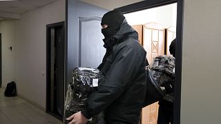 Police carry documents and computers out of the office of the Belarusian Association of Journalists in Minsk in February.