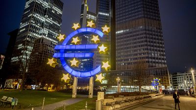  In this Thursday, March 11, 2021 file photo, a man walks past the Euro sculpture in Frankfurt, Germany.