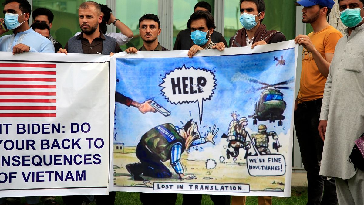 Former Afghan interpreters hold banners during a protest against the U.S. government and NATO in Kabul, Afghanistan on April 30, 2021.