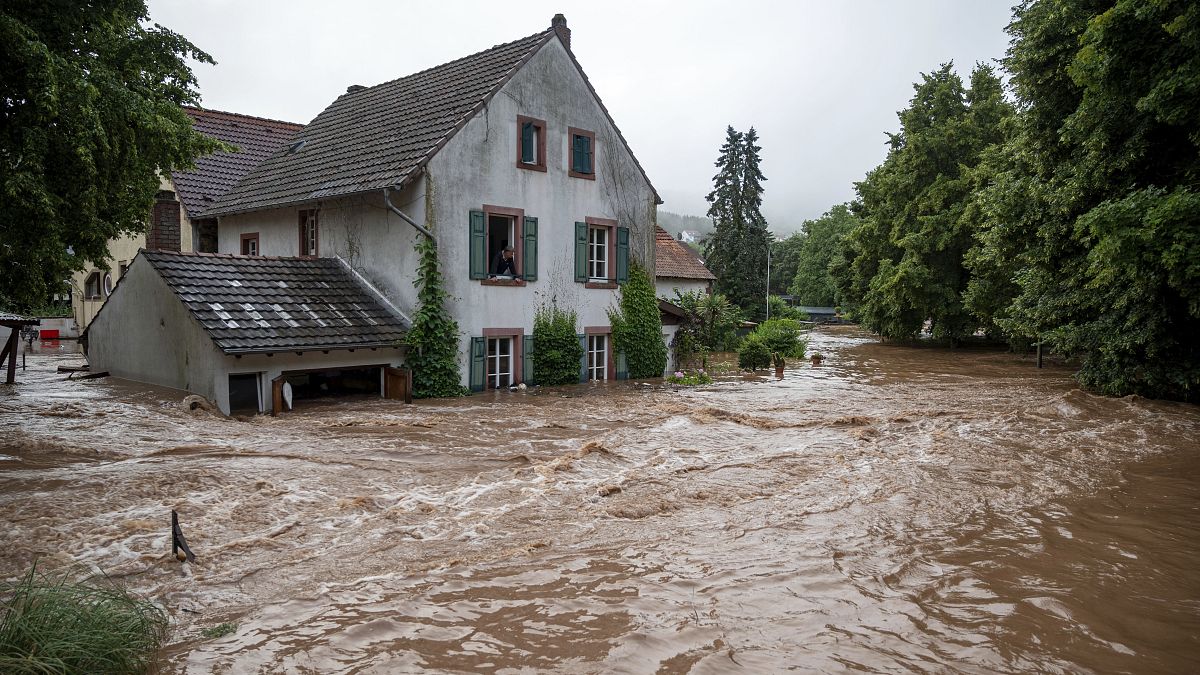 Houses are submerged on the overflowed river banks in Erdorf, Germany, as the village was flooded Thursday, July 15