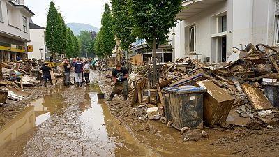 Residents clear mud and unusable furniture from houses in the city center of Bad Neuenahr, western Germany, Saturday, July 17, 2021. 