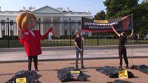  Activists protest outside White House as Biden hosts Merkel