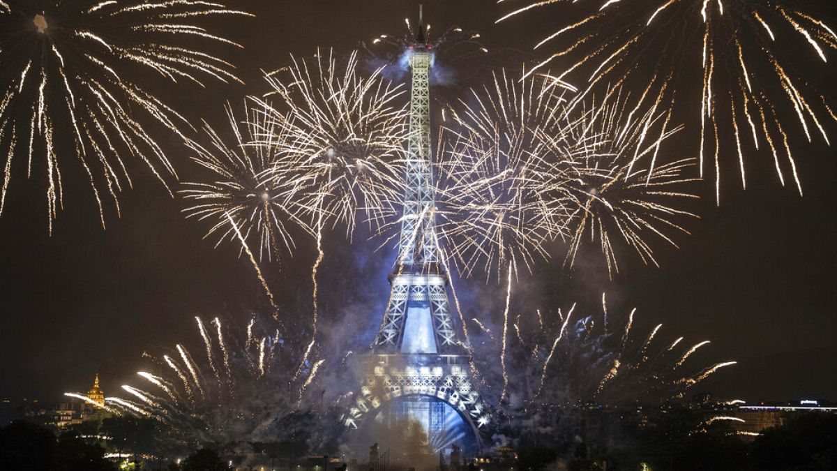 The Eiffel Tower was surrounded by fireworks to mark Bastille Day