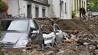 Cars are covered in Hagen, Germany, Thursday, July 15, 2021 with the debris brought by the flooding of the 'Nahma' river the night before.