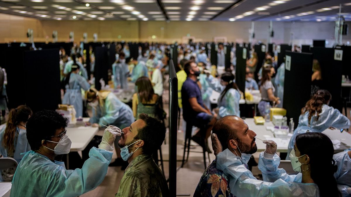 Health workers take swab samples collection for a Covid-19 antigen test ahead of the Cruilla music festival in Barcelona, Spain, July 9, 2021. 