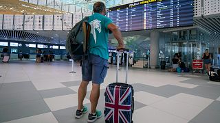 A passenger inspects the departures timetable at the international airport in Split, Croatia, on June 25, 2021.