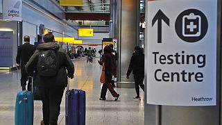 Travellers walk towards the Covid-19 testing centre at Heathrow Airport in London, Sunday, Jan. 17, 2021.