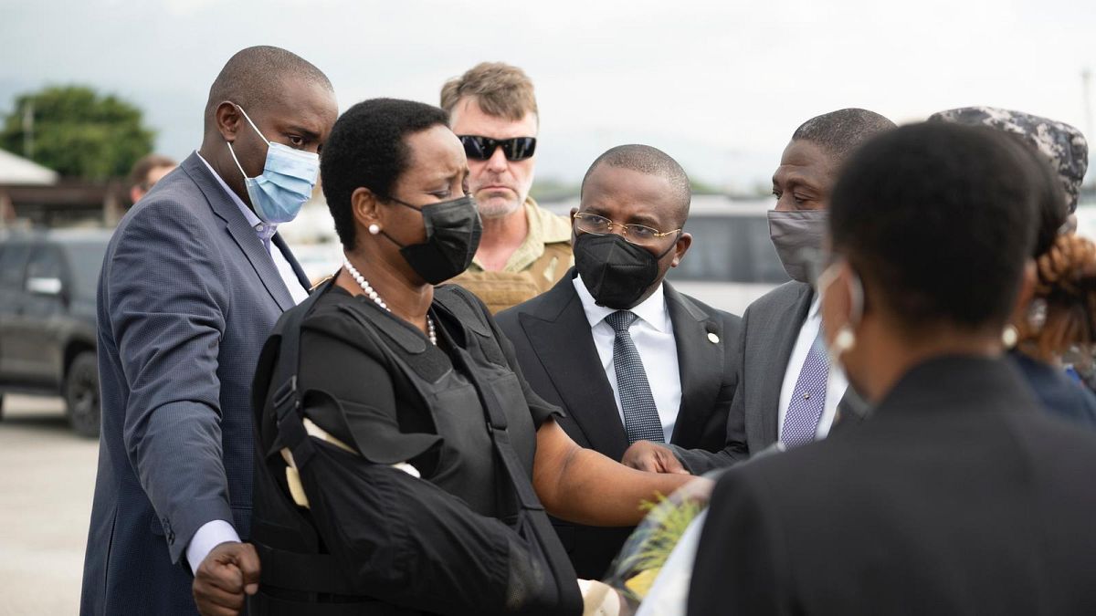 Haiti's first lady Martine Moise, wearing a bullet proof vest and her right arm in a sling, arrives in Port-au-Prince, Haiti, Saturday, July 17, 2021. 