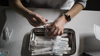 Nurse Coralie Ferron prepares doses of the Moderna COVID-19 vaccine at a vaccination center in Le Cannet, southern France, Thursday Jan. 21, 2021.