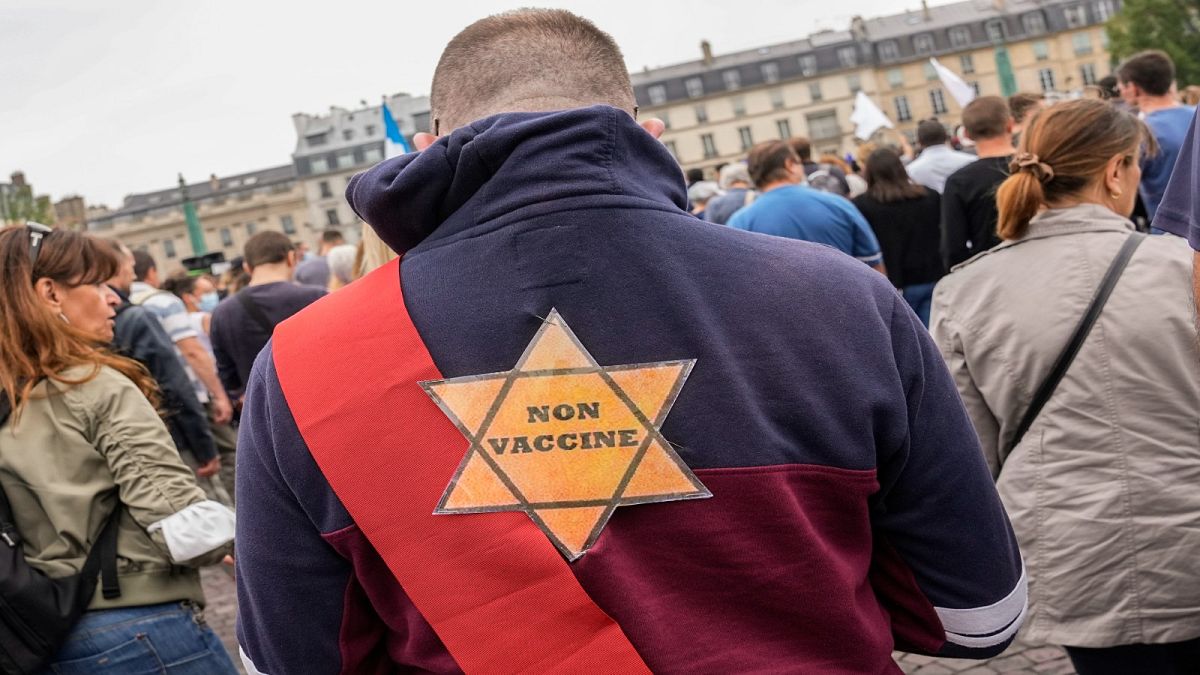 A star that reads, not vaccinated is attached on the back of an Anti-vaccine protesters during a rally in Paris, Saturday, July 17, 2021.