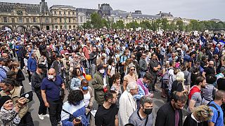 Anti-vaccine protesters march during a rally in Paris, Saturday, July 17, 2021.