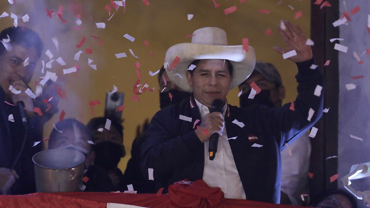 Pedro Castillo waves to supporters at his party's campaign headquarters in Lima, Peru, July 19, 2021, after election authorities declared him president-elect.