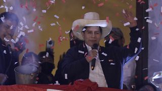 Pedro Castillo waves to supporters at his party's campaign headquarters in Lima, Peru, July 19, 2021, after election authorities declared him president-elect.