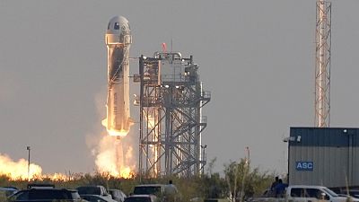 The New Shepard vehicle bearing Jeff Bezos and crew takes off from the launch pad in west Texas.