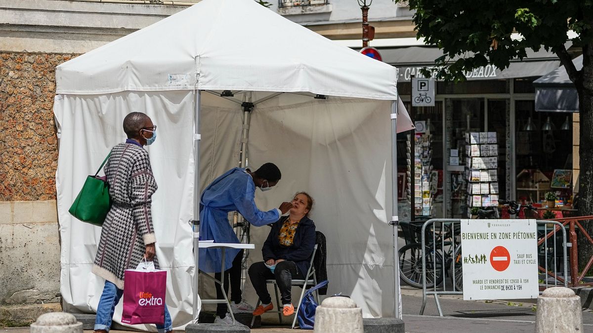 A medical technician administers nasal swabs at a mobile testing site in Versailles, west of Paris, Thursday, July 15, 2021.