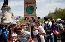 A young protester holds a bord reading « I love my planet » during a rally against the climate change in Paris, Sunday, May 9, 2021.