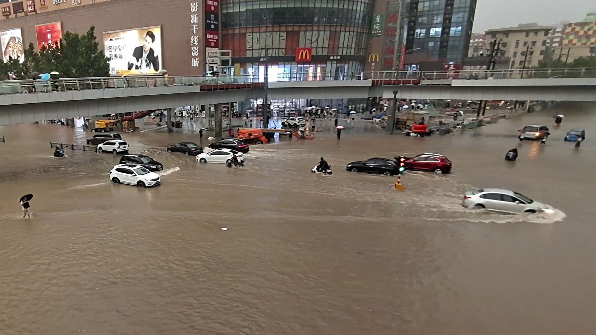 Vehicles are stranded after a heavy downpour in Zhengzhou city, central China