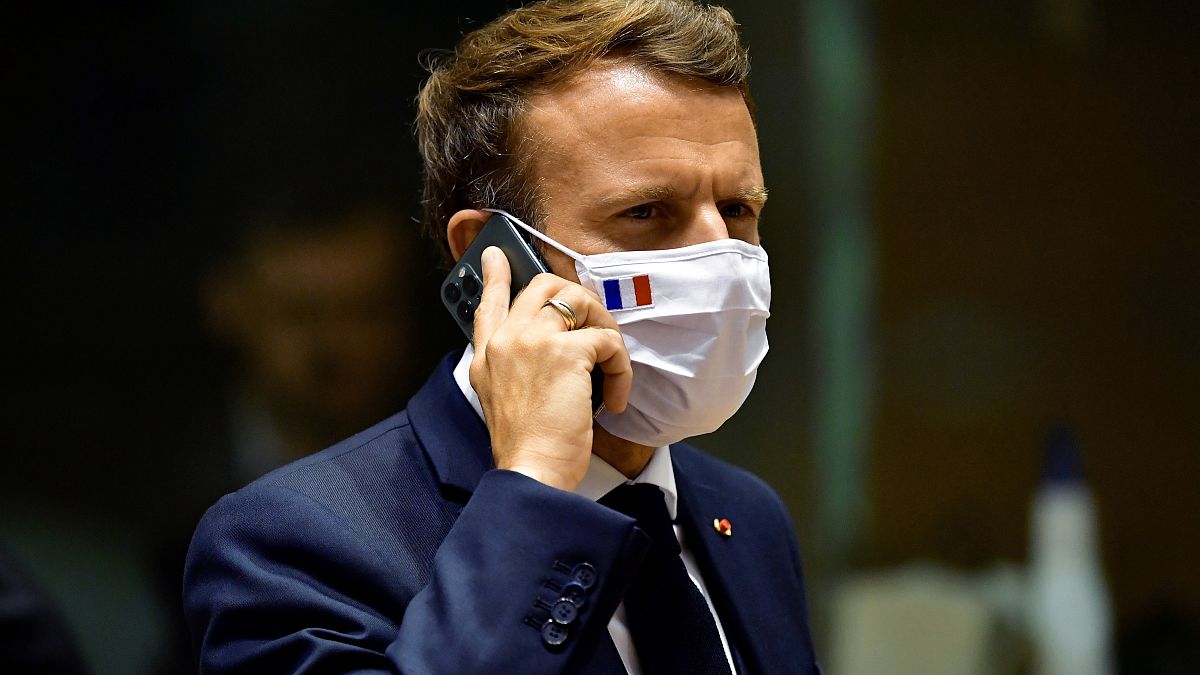 French President Emmanuel Macron speaks on his mobile phone