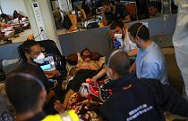 An ambulance is called for one of the migrants on hunger strike at the ULB Francophone university in Brussels on June 29, 2021