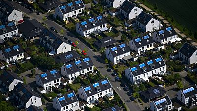 The aerial view shows a housing estate with solar panels on the roof in Duesseldorf, western Germany