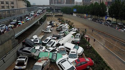 Flood aftermath: Pile up of cars on road in China