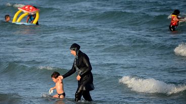 A Tunisian woman wearing a "burkini", a full-body swimsuit designed for Muslim women