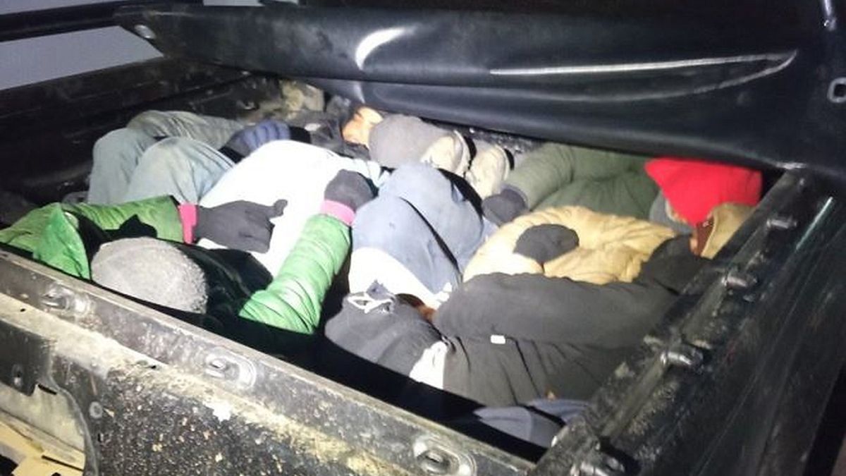 Migrants in the back of a vehicle stopped during the police operation